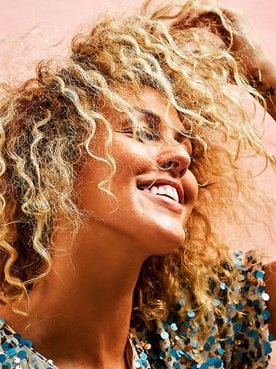 Modelo com cabelo loiro levemente ondulado