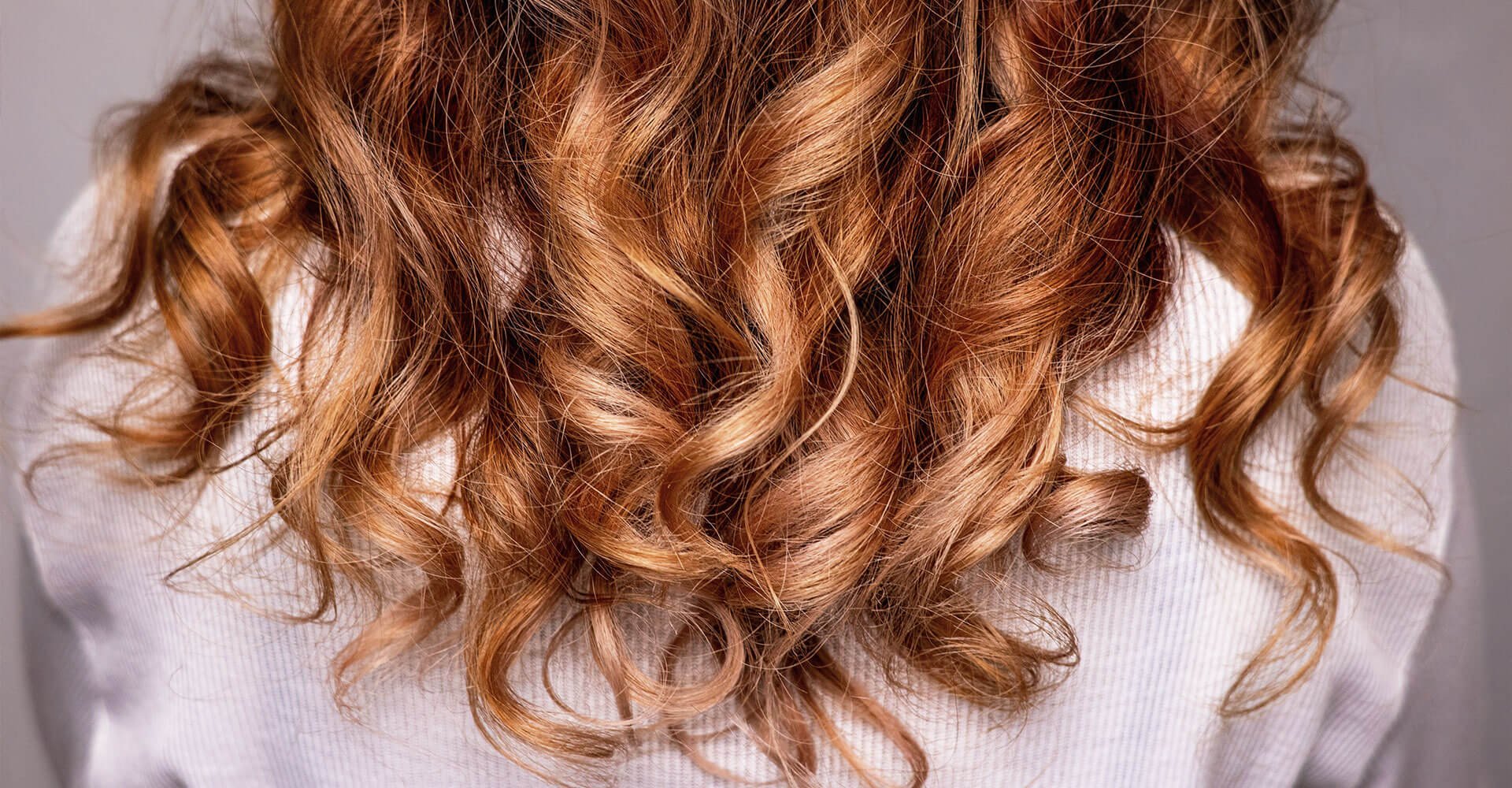 mulher com cabelo ondulados castanho avermelhado