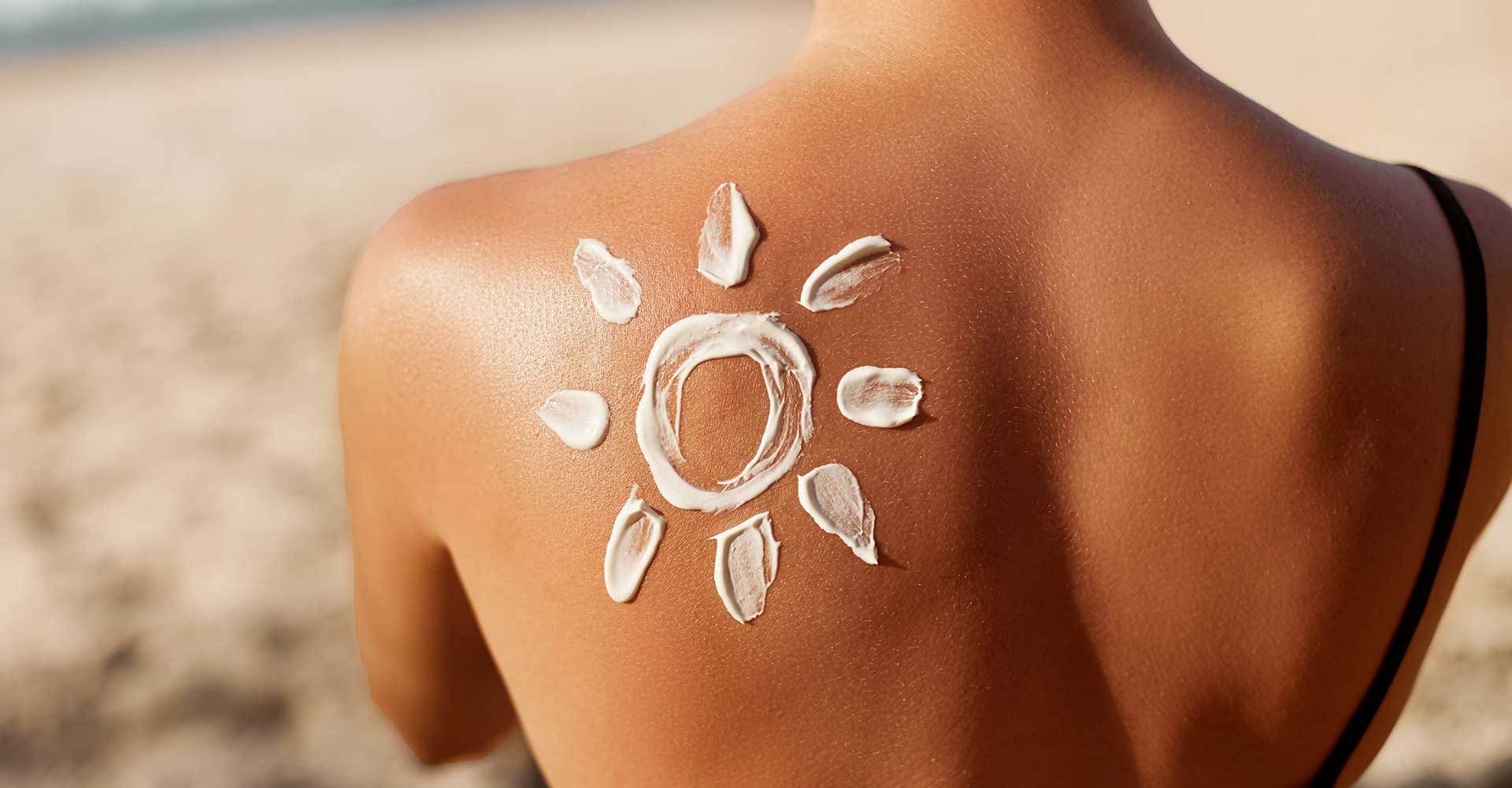 Imagem de uma mulher de costas com um sol feito de protetor solar