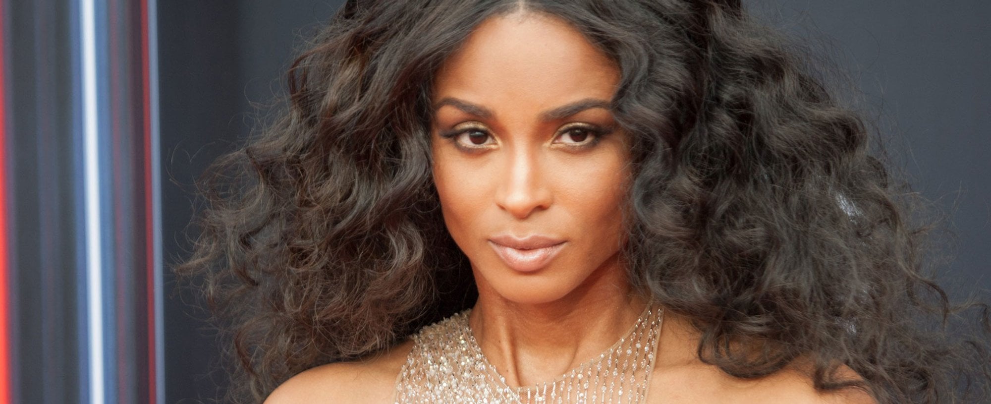 Mulher morena com cabelos pretos e ondulados e volumosos