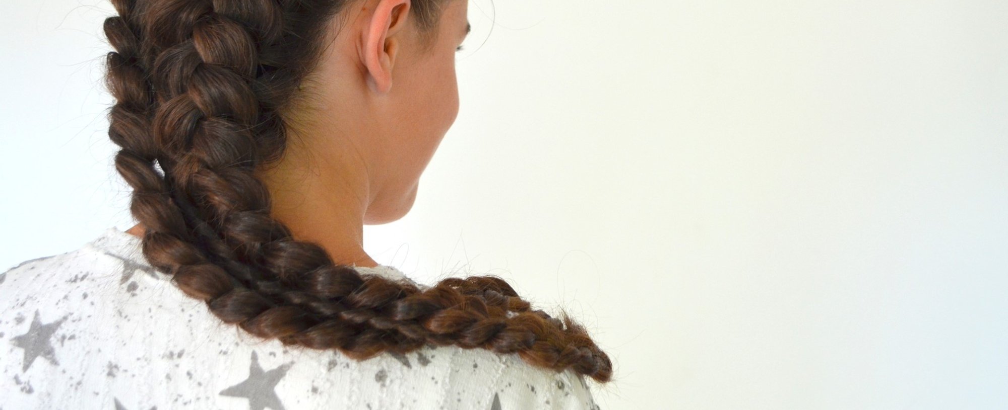 Modelo de costas com trança no cabelo