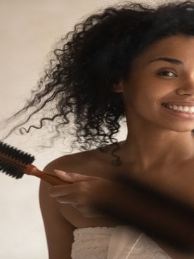 Modelo Negra Passando Escova De Pentear Em Seus Cachos