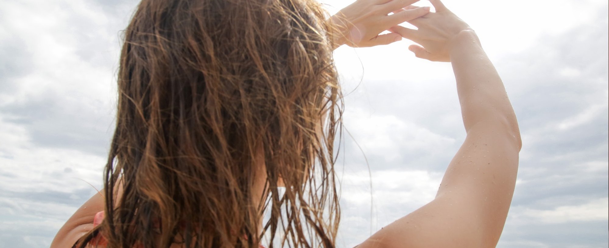Modelo com cabelo molhado no sol