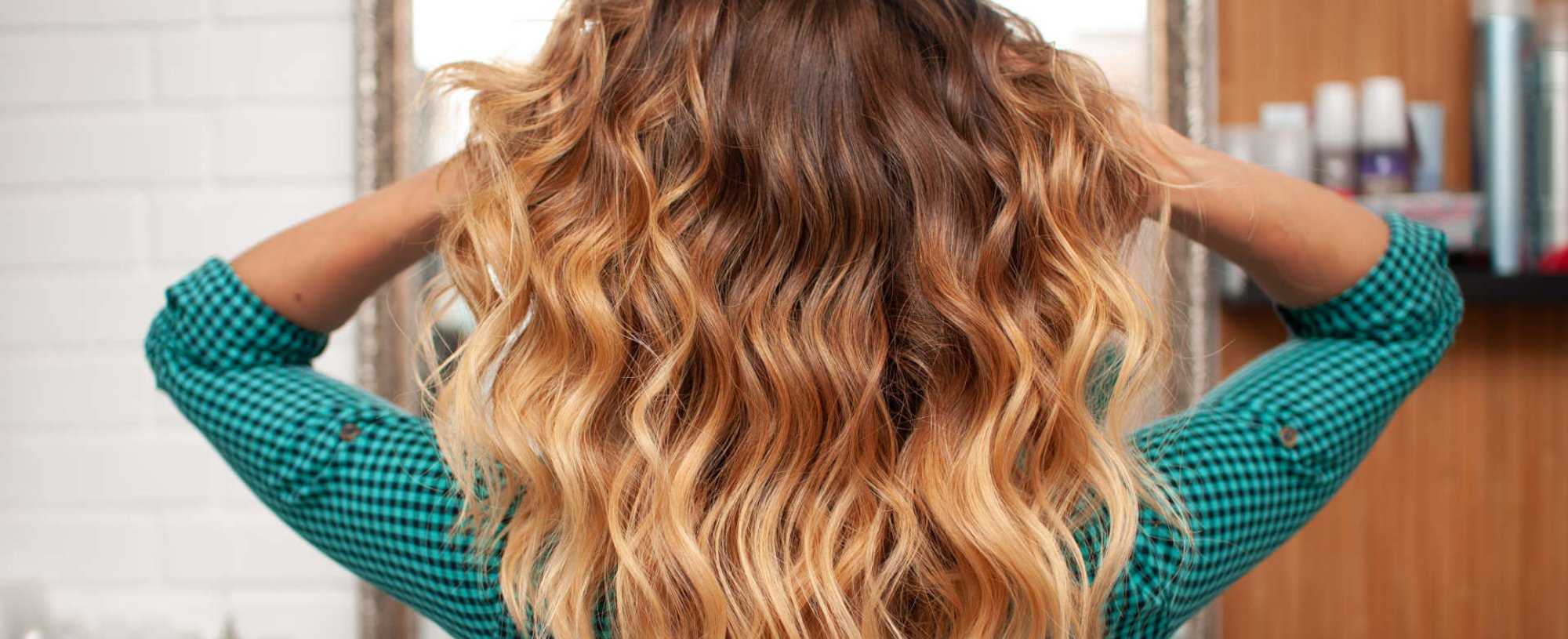 mulher exibe mechas e luzes de seu cabelo