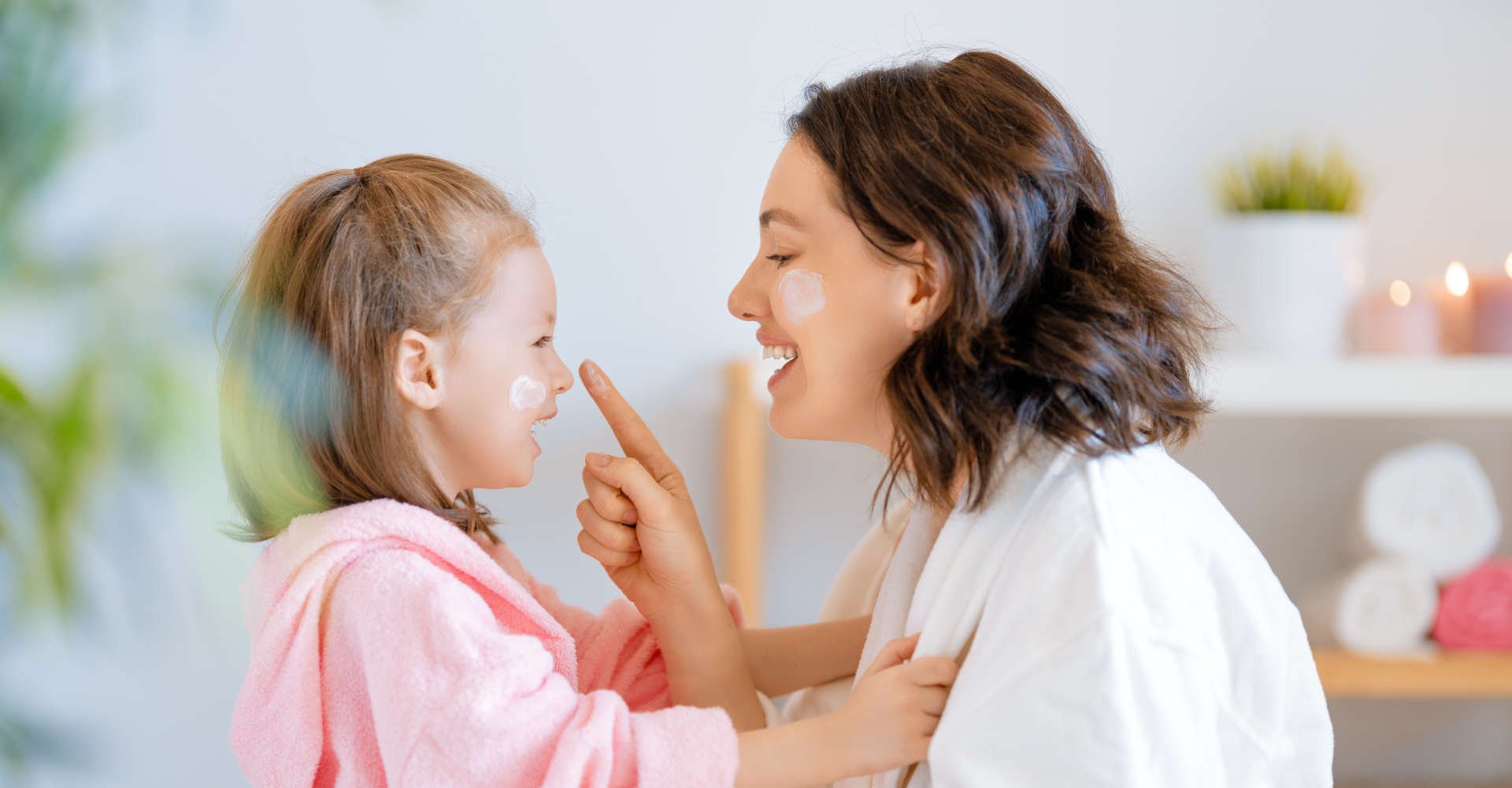 mãe e filha passando creme no rosto