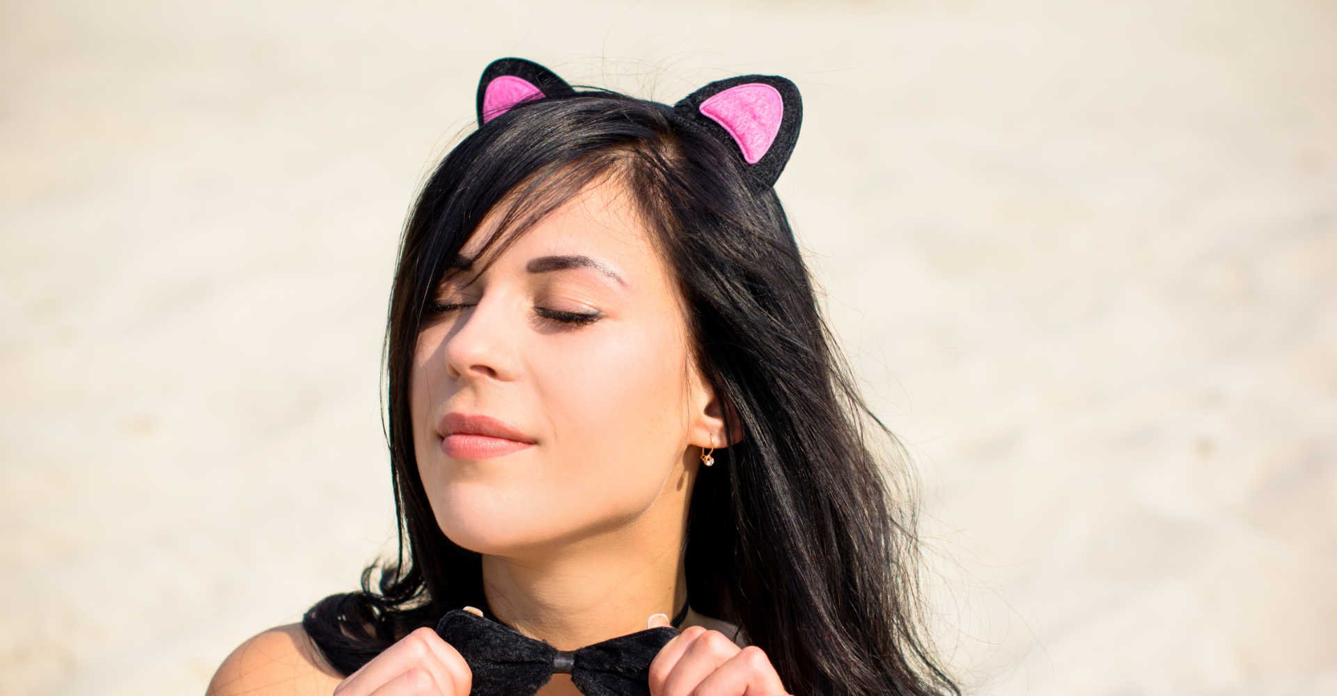 Modelo branca com acessório de orelha de gatinho no cabelo liso e preto