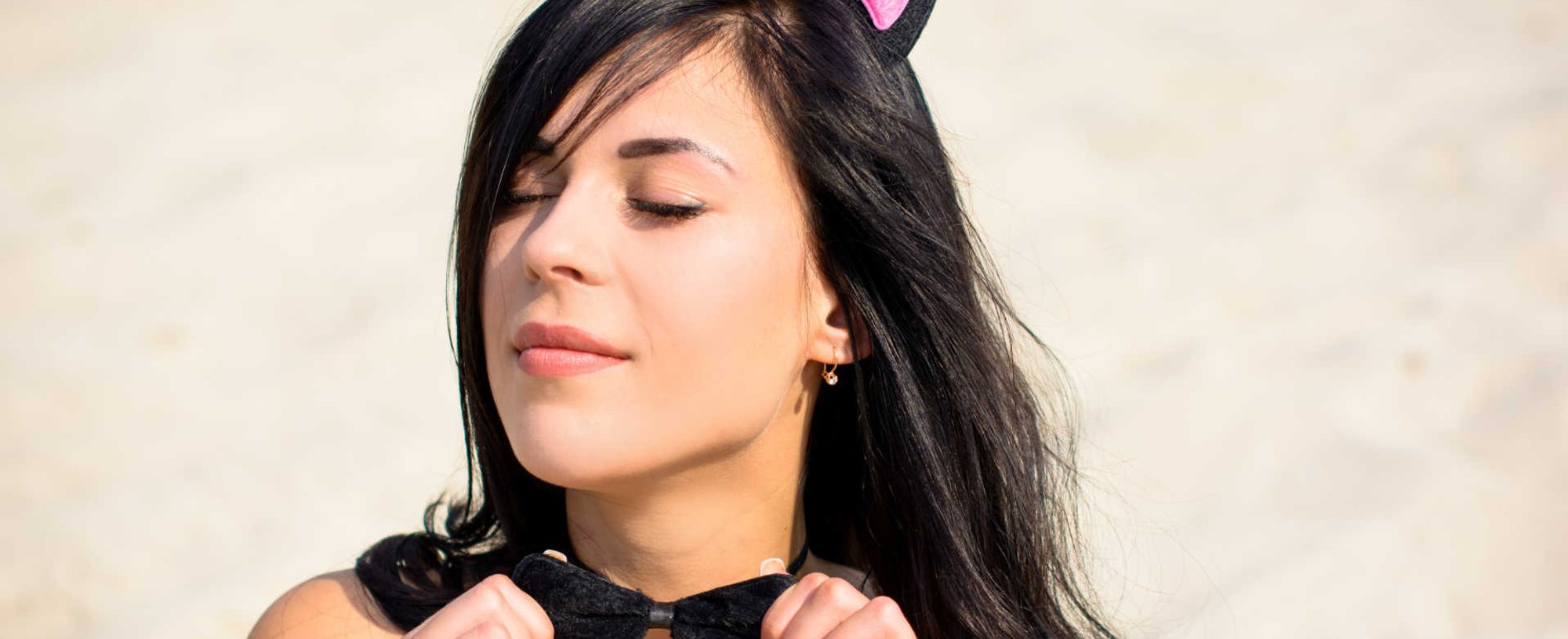 Modelo branca com acessório de orelha de gatinho no cabelo liso e preto